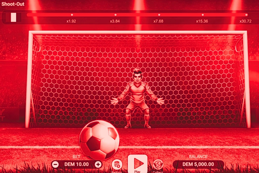 Interface du jeu Penalty Shoot-Out sur un casino en ligne, montrant un gardien de but devant les cages avec un ballon au premier plan, des multiplicateurs affichés en haut 1.92x, 3.84x, 7.68x, 15.36x et 30.72x, mise en mode démo DEM 10.00 en bas à gauche, et une balance de DEM 5,000.00 affichée, avec un bouton Play central prêt à lancer le tir.